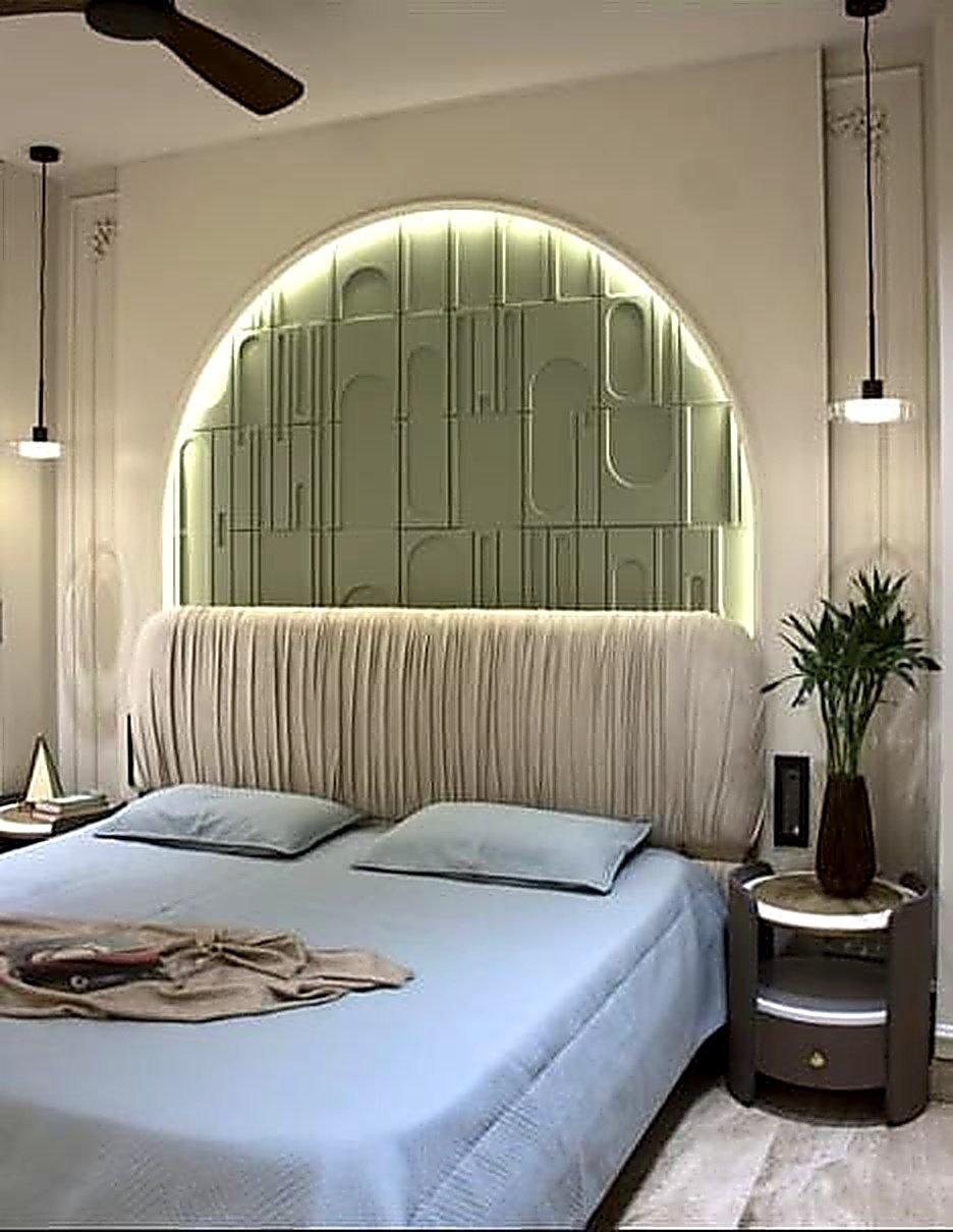 Bedroom with a sage arched headboard